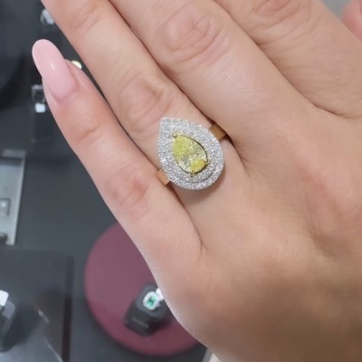 Ring with 1.03 ct Fancy Yellow Pear Cut 1.03 ct Center Diamond and 0.54 ct Side Diamonds